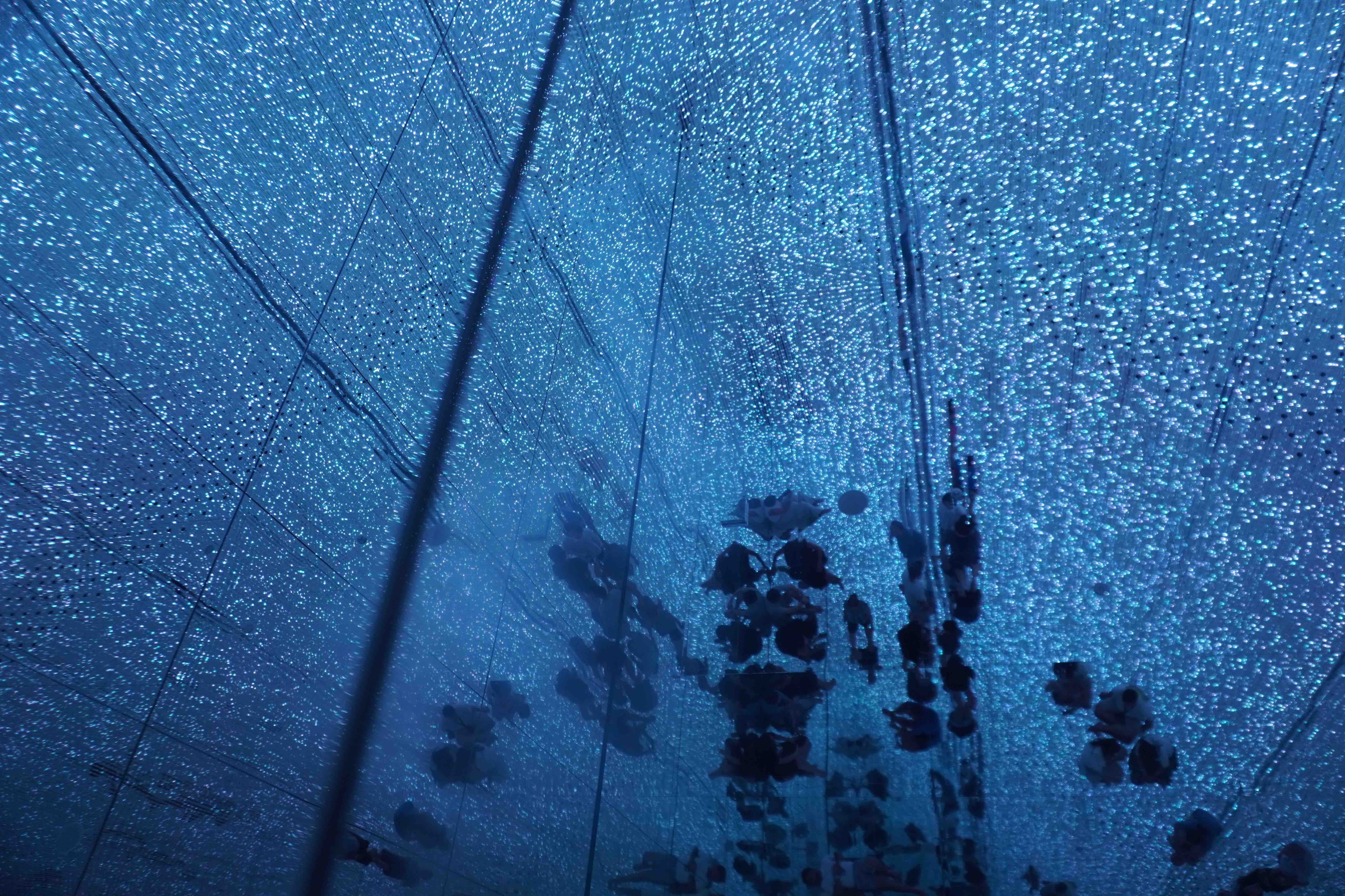 A hall-sized installation of glass and light that immerses visitors in an infinity mirror.