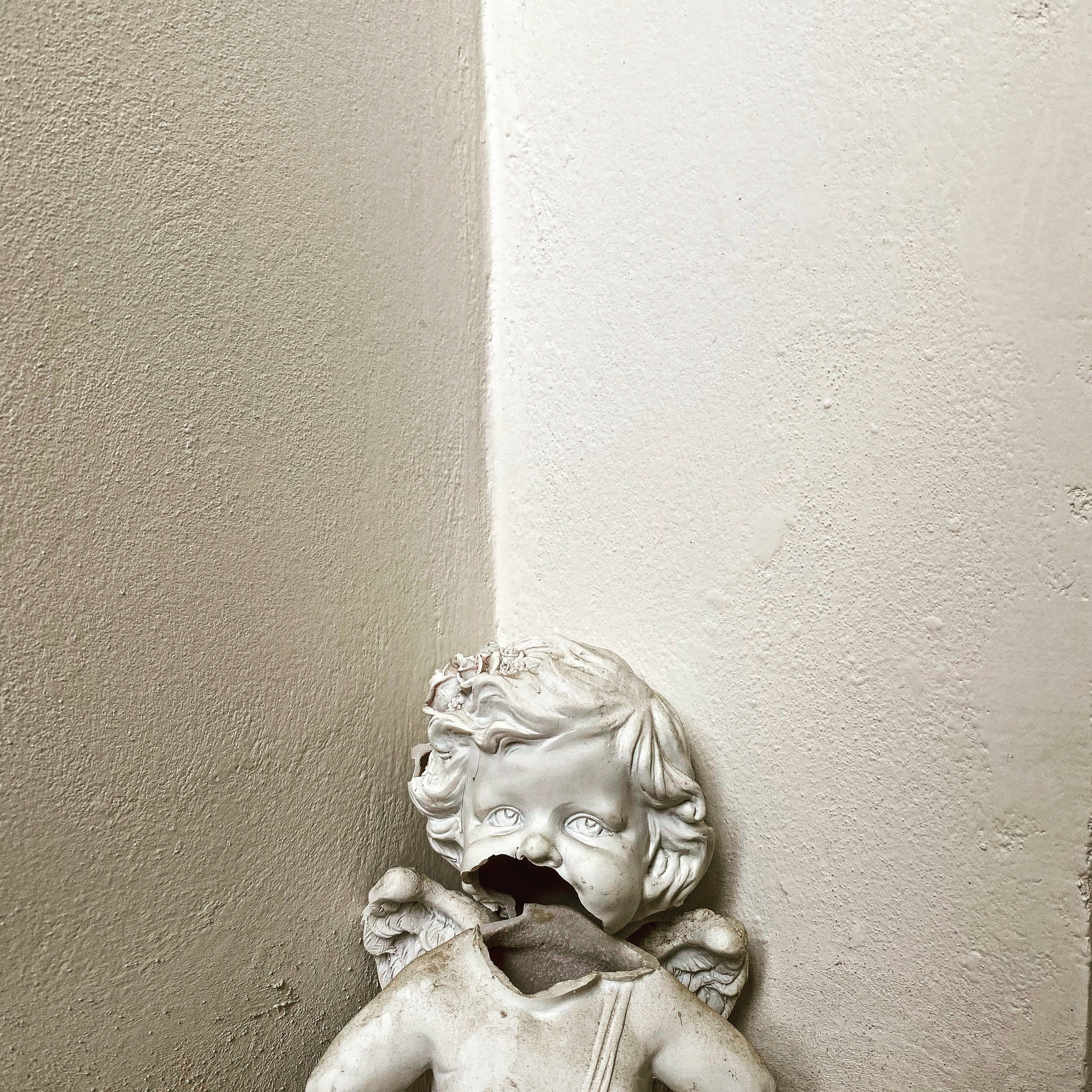 A ceramic cherub with a cracked face.
